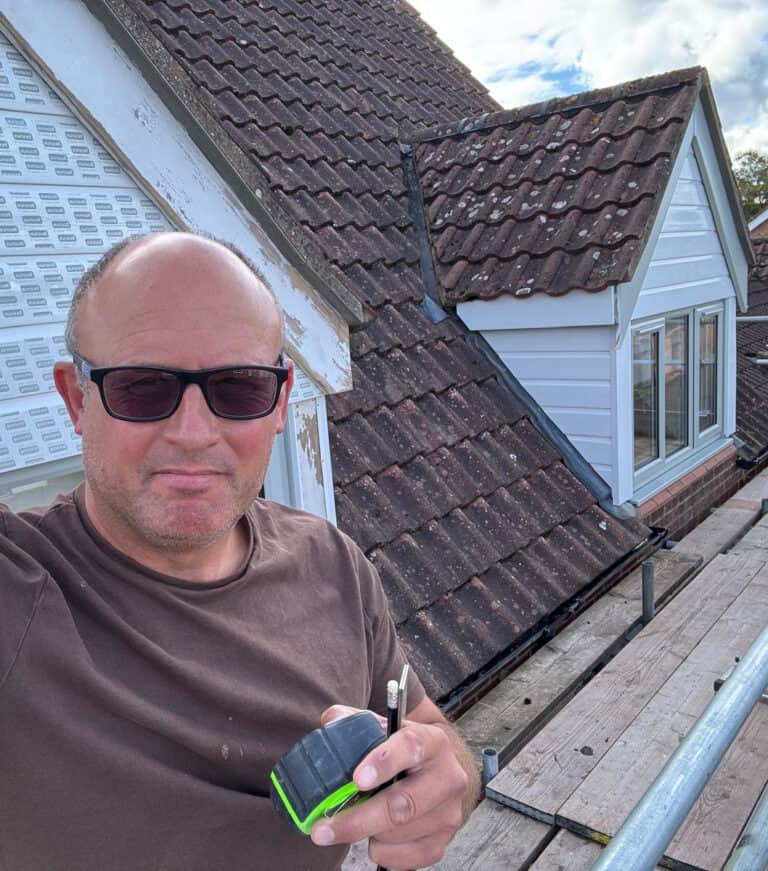 Jon on scaffolding replacing the fascia on an Aylsham house